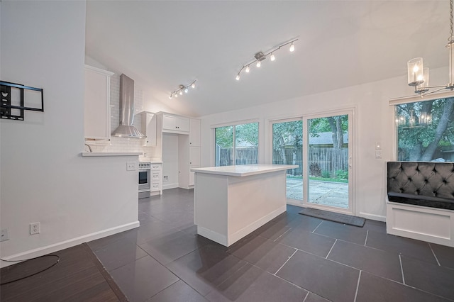 3407 Hillstone Dr, Sugar Land, TX 77479 - kitchen featuring wall chimney exhaust hood, vaulted ceiling, white cabinetry, tasteful backsplash, and light countertops