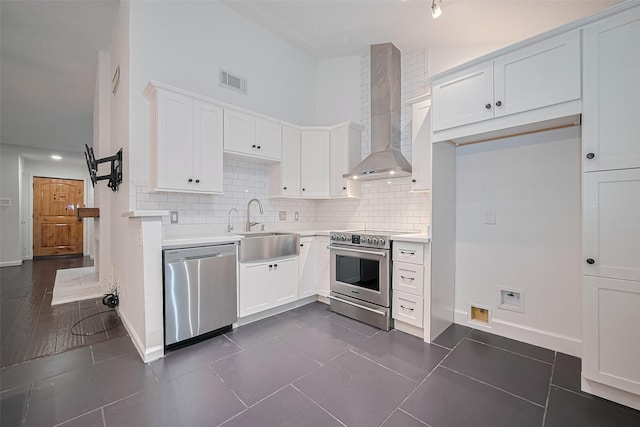 3407 Hillstone Dr, Sugar Land, TX 77479 - kitchen featuring stainless steel appliances, wall chimney exhaust hood, tasteful backsplash, white cabinets, and light countertops