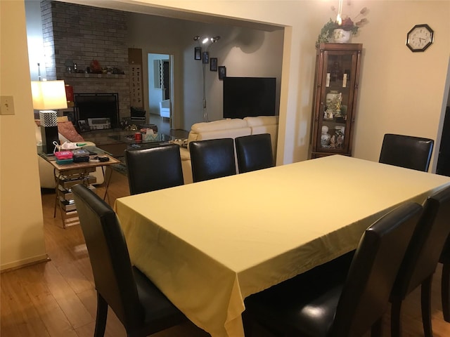 6203 Gladewell Dr, Houston, TX 77072 - dining room with wood finished floors and a fireplace