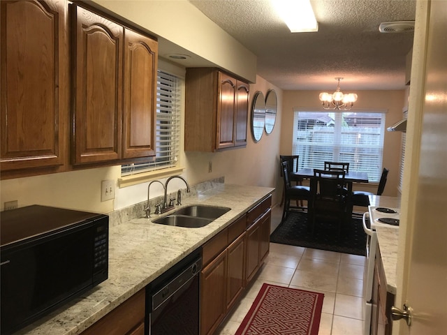 6203 Gladewell Dr, Houston, TX 77072 - kitchen featuring black appliances, a textured ceiling, a chandelier, light tile patterned flooring, and light stone countertops
