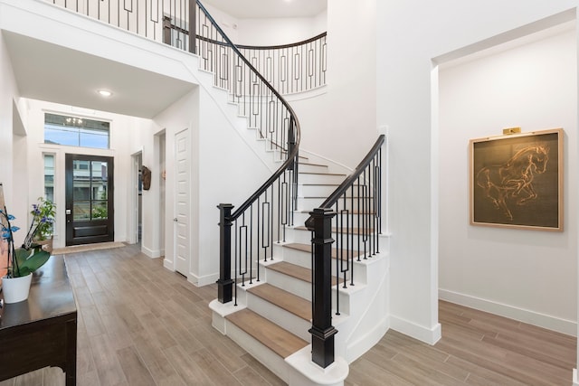 11111 Heartleaf Aster Way, Cypress, TX 77433 - foyer entrance featuring a high ceiling, wood finished floors, and stairs