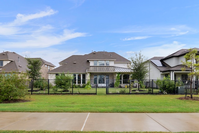 11111 Heartleaf Aster Way, Cypress, TX 77433 - rear view of house with a fenced front yard, a standing seam roof, and a metal roof