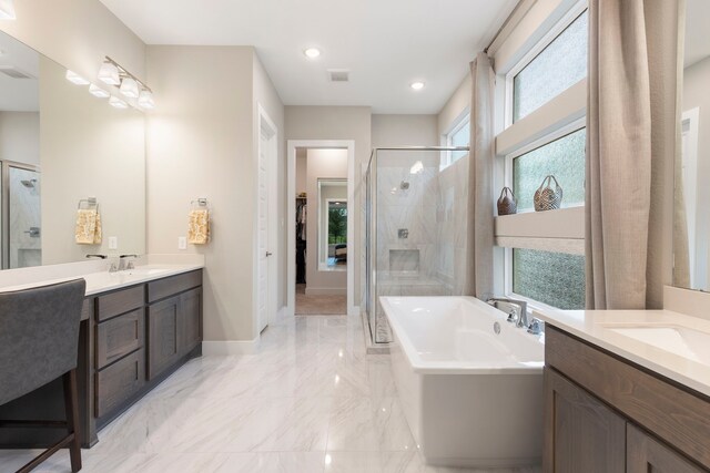 11111 Heartleaf Aster Way, Cypress, TX 77433 - bathroom featuring a shower stall, two vanities, a freestanding bath, marble tiled floors, and a walk in closet