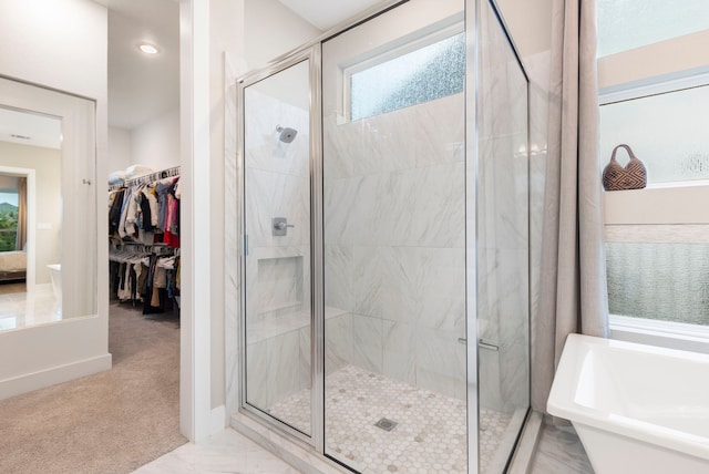 11111 Heartleaf Aster Way, Cypress, TX 77433 - bathroom featuring a freestanding bath, a stall shower, a walk in closet, and recessed lighting