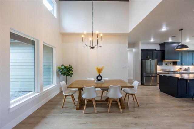 1000 Denson Allen Rd, Coldspring, TX 77331 - dining room with a chandelier, light wood-style floors, and a towering ceiling