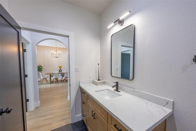 1000 Denson Allen Rd, Coldspring, TX 77331 - bathroom with vanity, wood finished floors, and a chandelier