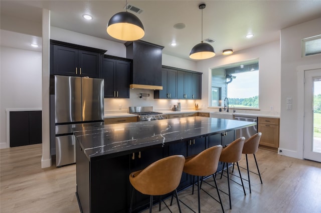 1000 Denson Allen Rd, Coldspring, TX 77331 - kitchen featuring stainless steel appliances, custom exhaust hood, light wood-style floors, a kitchen island, and recessed lighting