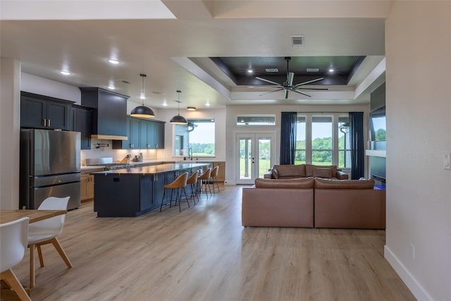 1000 Denson Allen Rd, Coldspring, TX 77331 - living area featuring light wood-style flooring, a ceiling fan, and a tray ceiling