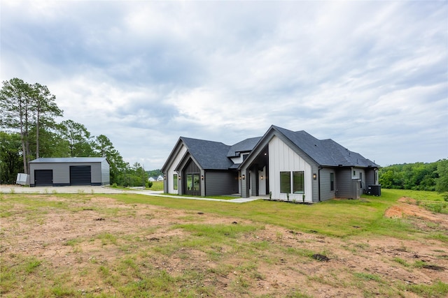 1000 Denson Allen Rd, Coldspring, TX 77331 - back of house featuring board and batten siding, a garage, a yard, and an outbuilding