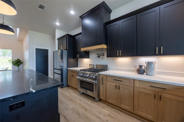 1000 Denson Allen Rd, Coldspring, TX 77331 - kitchen featuring appliances with stainless steel finishes, custom exhaust hood, light wood-style floors, light stone countertops, and recessed lighting