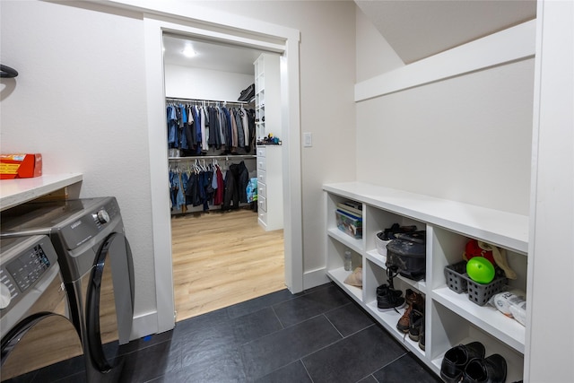 1000 Denson Allen Rd, Coldspring, TX 77331 - washroom with washer and clothes dryer and dark tile patterned flooring