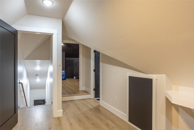 1000 Denson Allen Rd, Coldspring, TX 77331 - hall with light wood-type flooring, lofted ceiling, and a textured ceiling
