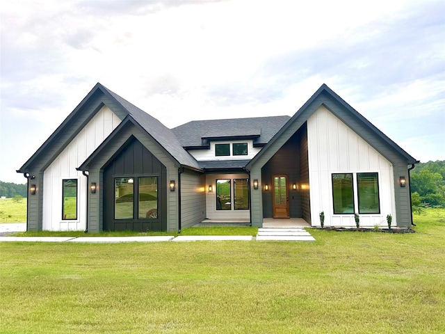 1000 Denson Allen Rd, Coldspring, TX 77331 - view of front facade featuring board and batten siding, a front lawn, and roof with shingles