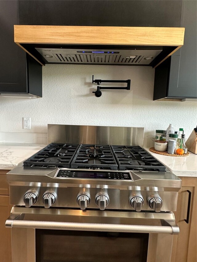 1000 Denson Allen Rd, Coldspring, TX 77331 - detailed view of high end range, pot filler, and ventilation hood