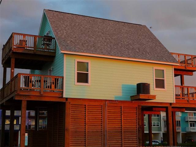 110 Pelican Pl, Surfside Beach, TX 77541 - rear view of house featuring a balcony, a shingled roof, and a wooden deck