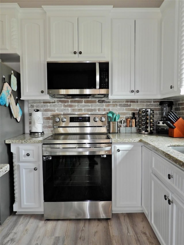 110 Pelican Pl, Surfside Beach, TX 77541 - kitchen featuring stainless steel appliances and white cabinetry