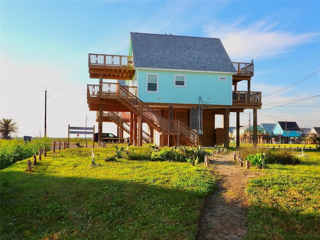 110 Pelican Pl, Surfside Beach, TX 77541 - rear view of house featuring stairway, a shingled roof, and a deck