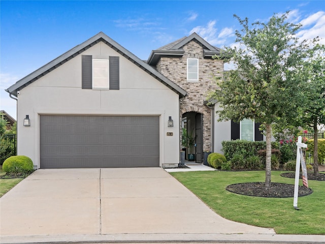 18114 Rainwater Creek Ln, Cypress, TX 77433 - view of front facade featuring stone siding, a front yard, and stucco siding