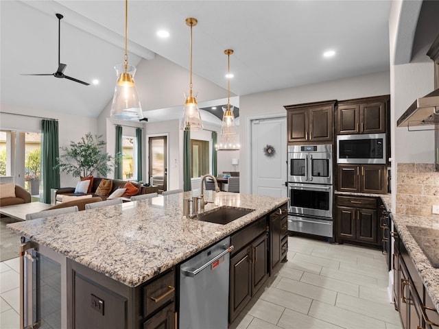 18114 Rainwater Creek Ln, Cypress, TX 77433 - kitchen with appliances with stainless steel finishes, open floor plan, a warming drawer, wine cooler, and a ceiling fan
