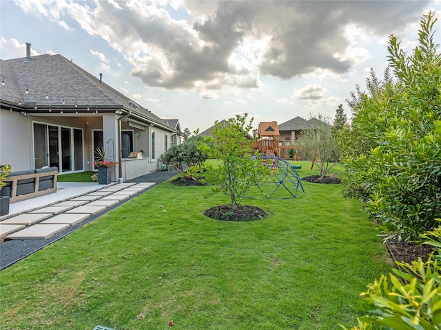 18114 Rainwater Creek Ln, Cypress, TX 77433 - view of green lawn featuring a patio area