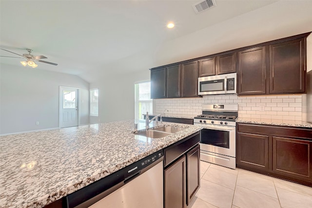 3227 Zephyr Park Ln, Katy, TX 77494 - kitchen featuring stainless steel appliances, lofted ceiling, backsplash, light stone countertops, and a ceiling fan