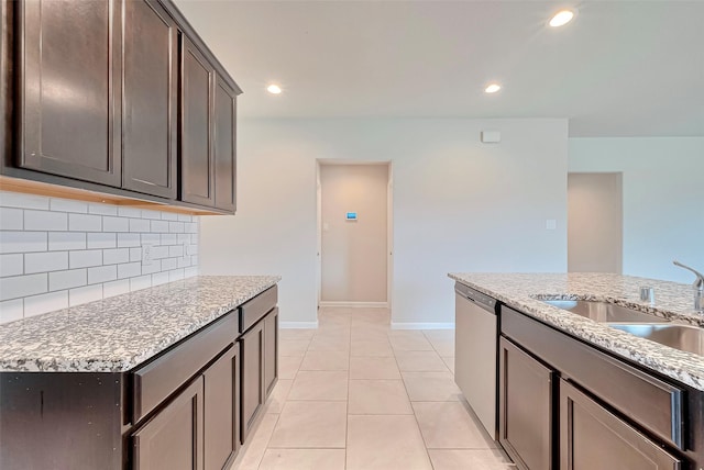 3227 Zephyr Park Ln, Katy, TX 77494 - kitchen featuring dishwasher, tasteful backsplash, dark brown cabinets, recessed lighting, and light stone countertops