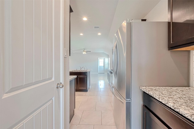 3227 Zephyr Park Ln, Katy, TX 77494 - kitchen with freestanding refrigerator, dark brown cabinetry, recessed lighting, a ceiling fan, and light tile patterned floors