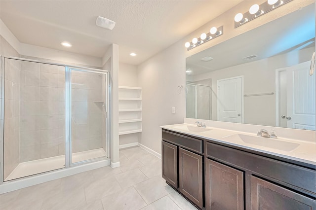 3227 Zephyr Park Ln, Katy, TX 77494 - full bath featuring tile patterned floors, double vanity, a stall shower, recessed lighting, and a textured ceiling