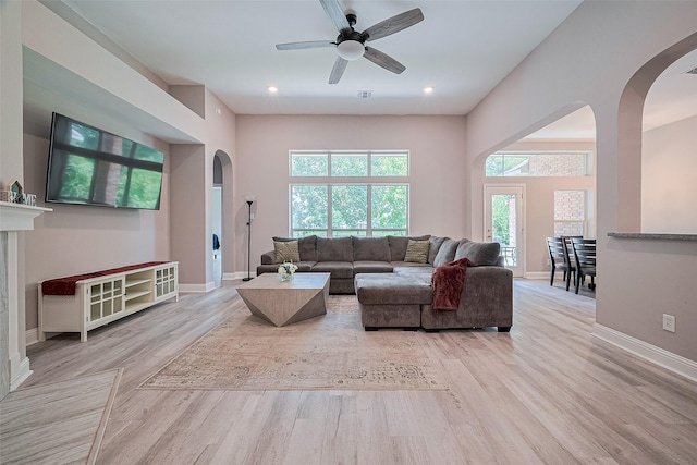 6507 Pinewood Trace Ln, Houston, TX 77041 - living area featuring arched walkways, healthy amount of natural light, wood finished floors, and ceiling fan