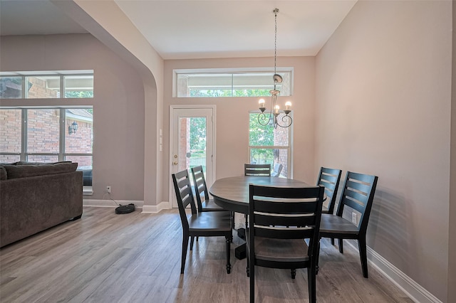 6507 Pinewood Trace Ln, Houston, TX 77041 - dining space with wood finished floors, a chandelier, and arched walkways