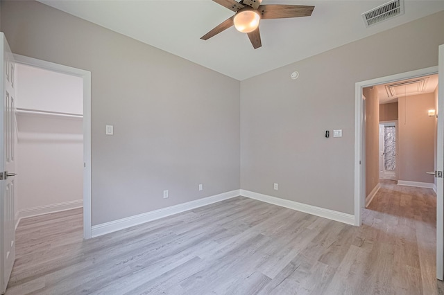 6507 Pinewood Trace Ln, Houston, TX 77041 - unfurnished bedroom with attic access, light wood-style floors, a walk in closet, a ceiling fan, and a closet