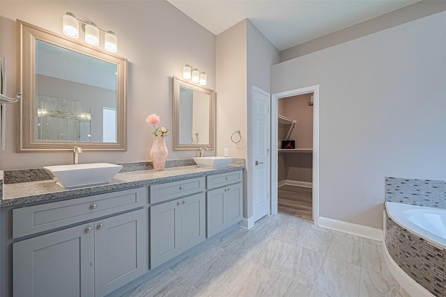 6507 Pinewood Trace Ln, Houston, TX 77041 - full bathroom featuring double vanity, a tile shower, tiled tub, marble look tiles, and a spacious closet