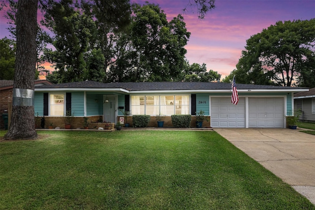 2801 John St, La Marque, TX 77568 - ranch-style house featuring a garage, driveway, a front yard, and brick siding