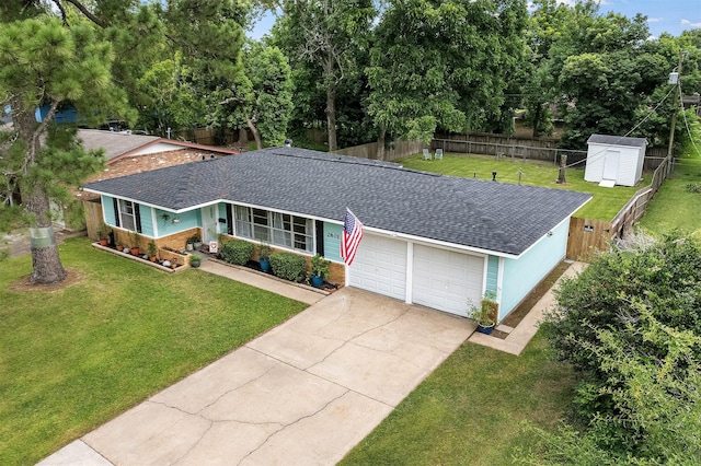 2801 John St, La Marque, TX 77568 - single story home featuring roof with shingles, a garage, concrete driveway, a fenced backyard, and a storage shed