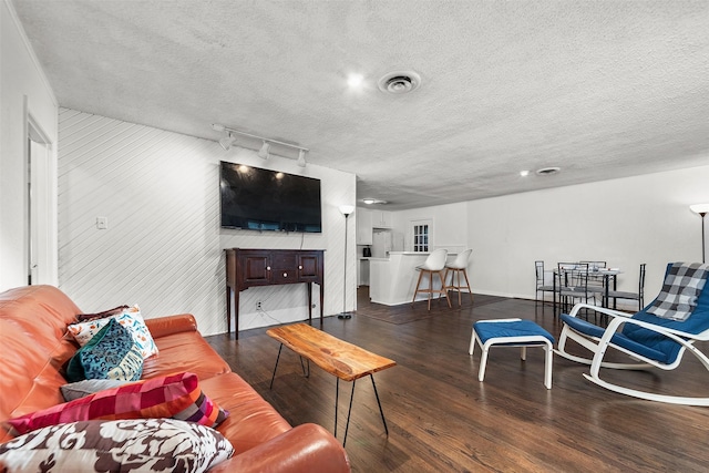 2801 John St, La Marque, TX 77568 - living room featuring wood finished floors, rail lighting, and a textured ceiling