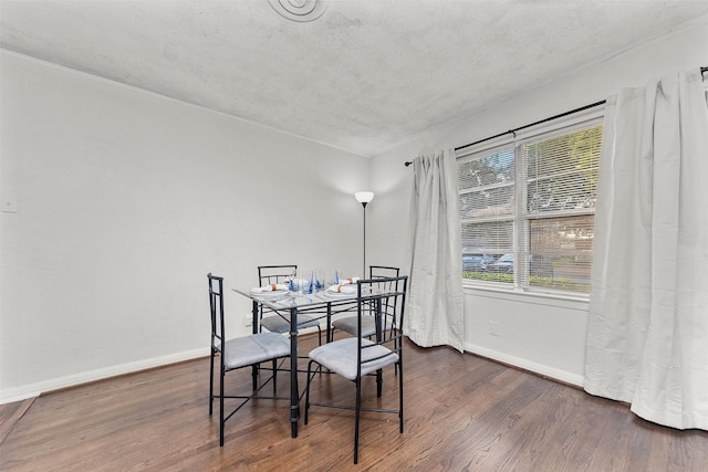 2801 John St, La Marque, TX 77568 - dining room featuring dark wood finished floors and a textured ceiling
