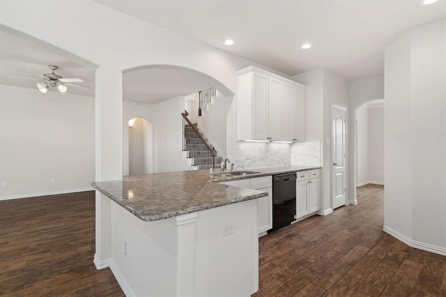 24727 Lake Basin Ct, Katy, TX 77493 - kitchen featuring dishwasher, arched walkways, a ceiling fan, dark wood-style flooring, and tasteful backsplash