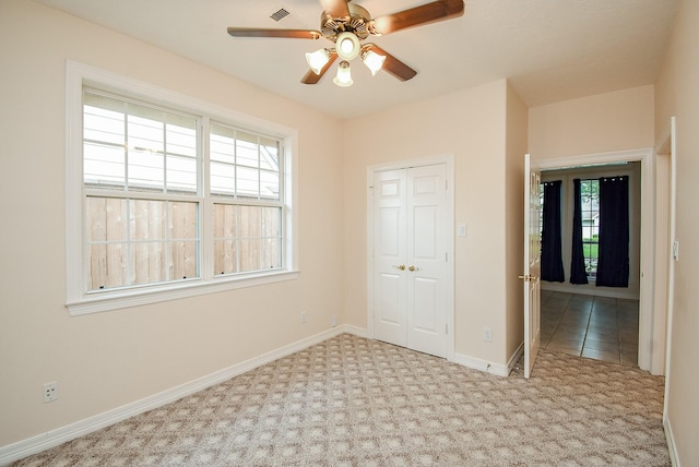 3003 Bernadette Ln, Houston, TX 77043 - unfurnished bedroom featuring multiple windows, carpet flooring, and a closet