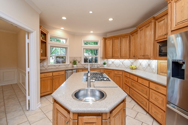 3003 Bernadette Ln, Houston, TX 77043 - kitchen featuring appliances with stainless steel finishes, a center island with sink, light stone countertops, ornamental molding, and light tile patterned floors
