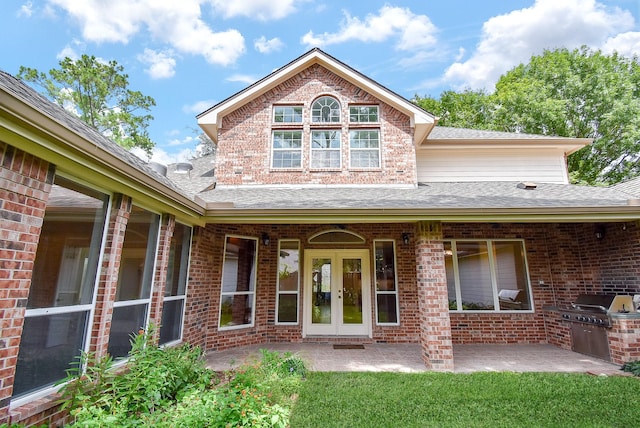 3003 Bernadette Ln, Houston, TX 77043 - view of exterior entry featuring brick siding, a shingled roof, exterior kitchen, french doors, and a patio