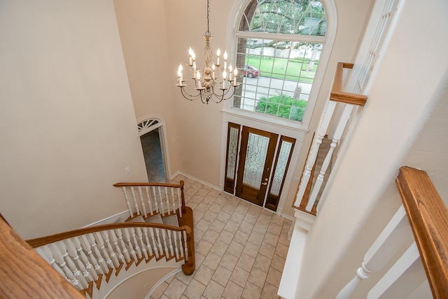 3003 Bernadette Ln, Houston, TX 77043 - entryway featuring a chandelier, a towering ceiling, light tile patterned flooring, and stairs