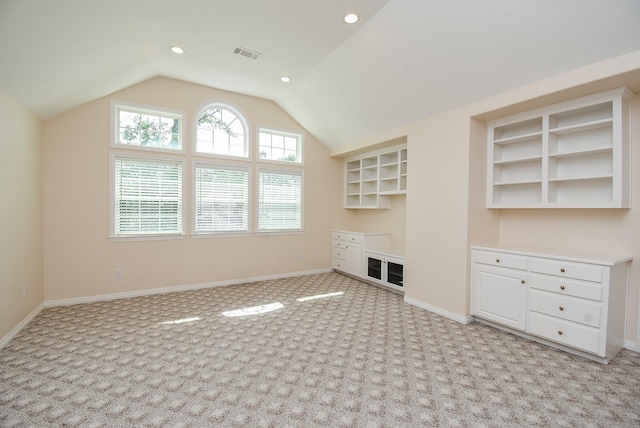 3003 Bernadette Ln, Houston, TX 77043 - unfurnished living room with light carpet, lofted ceiling, and recessed lighting