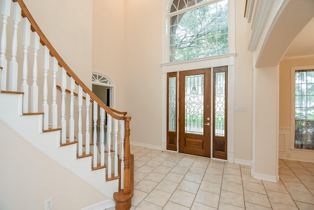 3003 Bernadette Ln, Houston, TX 77043 - foyer featuring light tile patterned flooring, stairs, and a towering ceiling