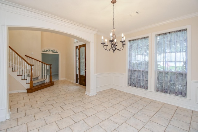 3003 Bernadette Ln, Houston, TX 77043 - empty room featuring a chandelier, crown molding, arched walkways, stairs, and light tile patterned floors