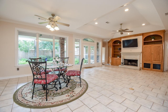 3003 Bernadette Ln, Houston, TX 77043 - dining space with ceiling fan, french doors, recessed lighting, light tile patterned floors, and a fireplace with raised hearth