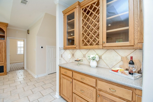 3003 Bernadette Ln, Houston, TX 77043 - bar area featuring ornamental molding, decorative backsplash, and light tile patterned flooring