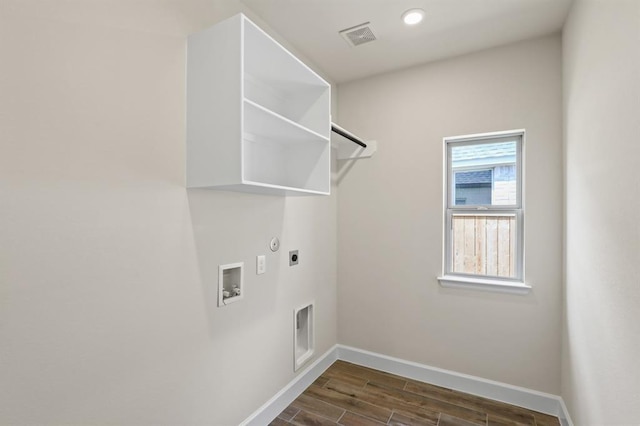 18511 Wolf Mountain Ln, Cypress, TX 77433 - laundry room featuring hookup for an electric dryer, washer hookup, dark wood finished floors, gas dryer hookup, and recessed lighting