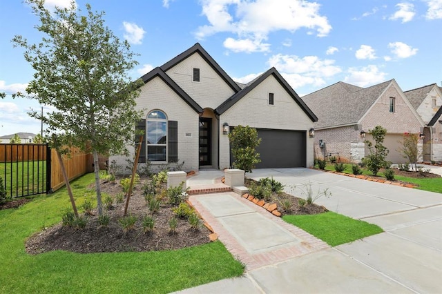 18511 Wolf Mountain Ln, Cypress, TX 77433 - french country inspired facade featuring brick siding, concrete driveway, and a garage
