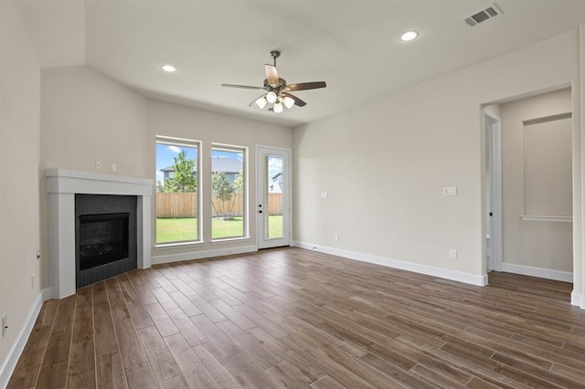 18511 Wolf Mountain Ln, Cypress, TX 77433 - unfurnished living room featuring ceiling fan, dark wood-style floors, a glass covered fireplace, and recessed lighting