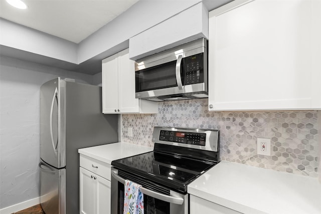 8101 Amelia Rd Unit 509, Houston, TX 77055 - kitchen with appliances with stainless steel finishes, light countertops, white cabinetry, and decorative backsplash